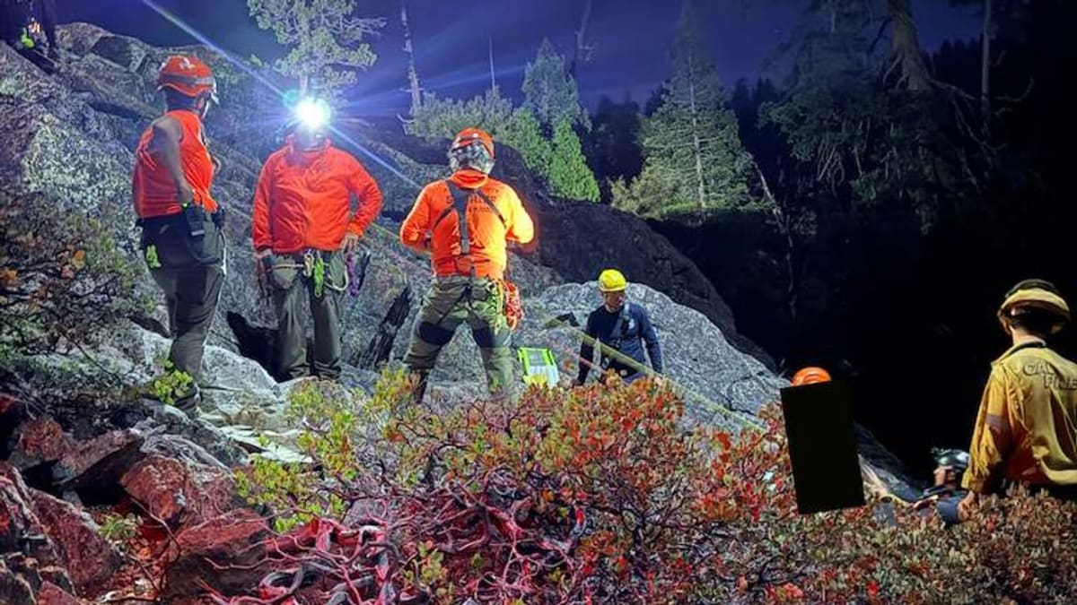 Rescue teams using rope systems to save woman stranded on boulder in Nevada river canyon