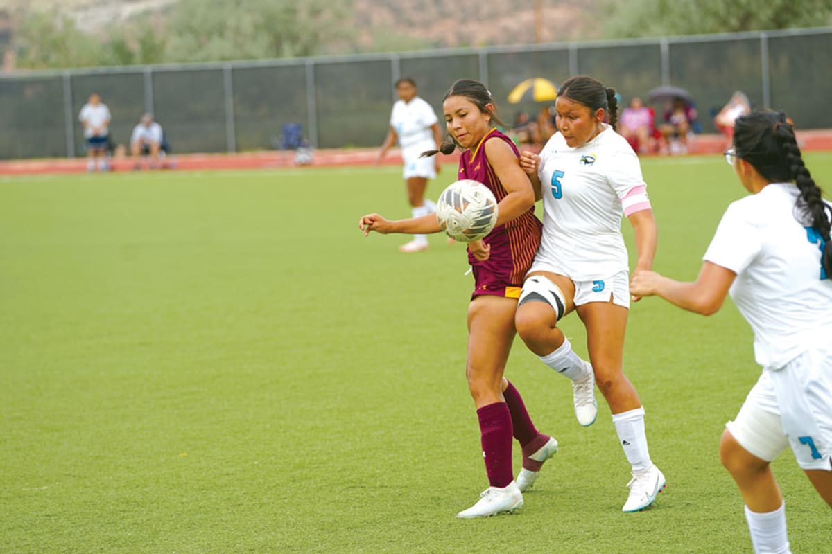 Navajo Prep soccer player Isabella Yazzie battles for ball possession during tournament championship game