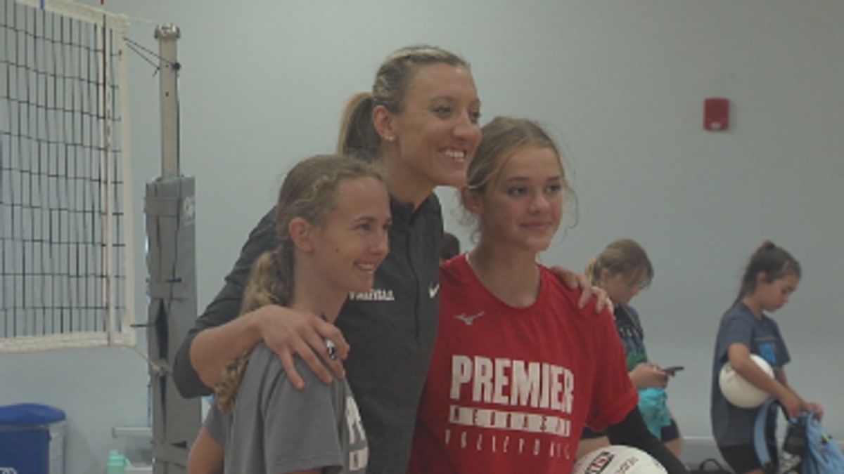 ** Jordan Larson posing with young volleyball campers at All-Skills Camp in Lincoln, Nebraska