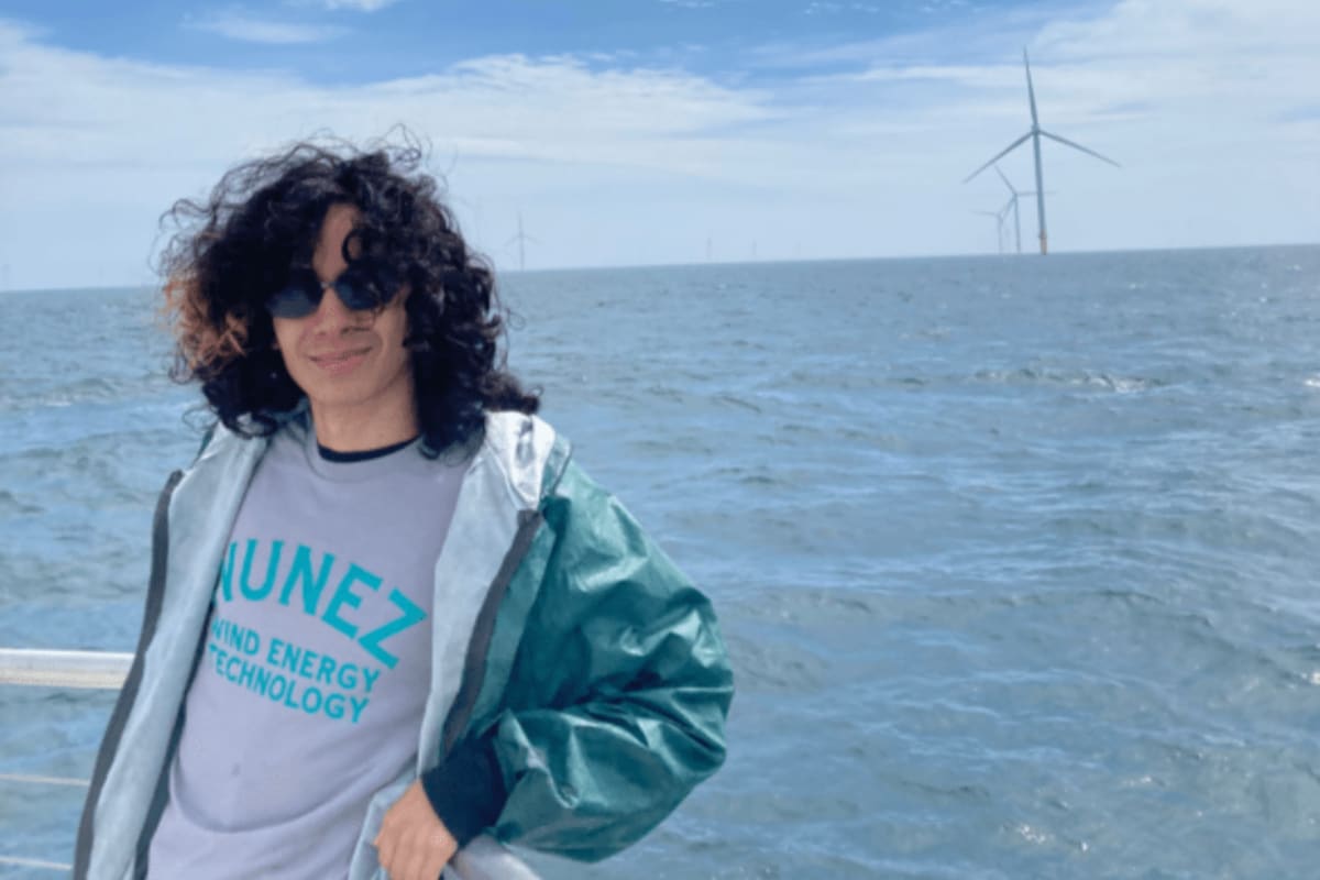Nunez Community College student Walker Argao on boat approaching massive offshore wind turbines in New England