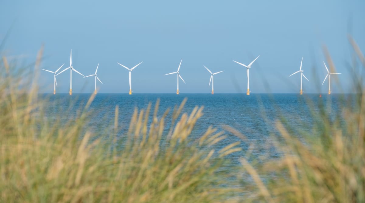 Offshore wind turbines standing tall in ocean waters generating clean renewable energy