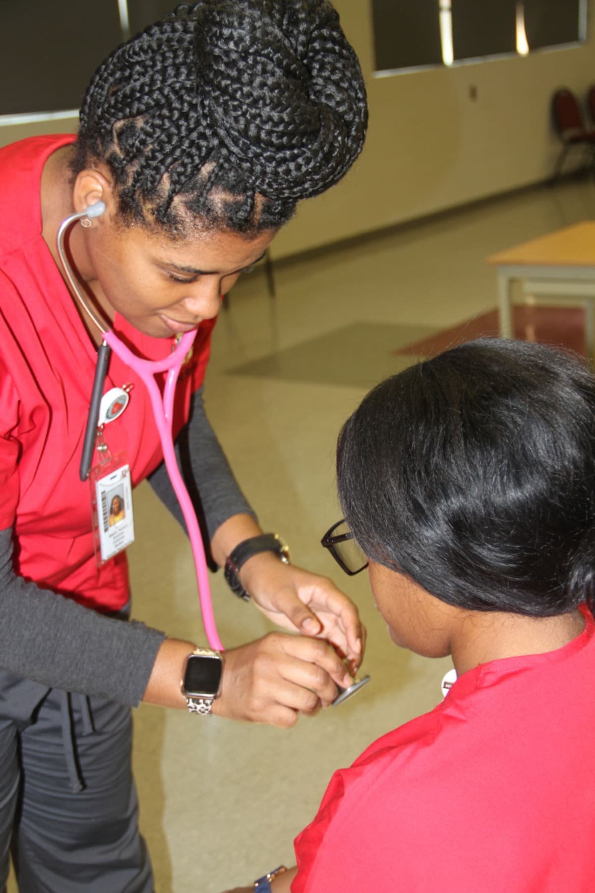 Nursing student in scrubs studying at Holmes Community College in Mississippi