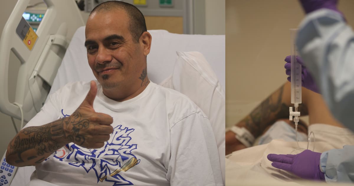 Cancer patient David Gutierrez sitting in treatment chair receiving chemotherapy through hepatic artery infusion pump