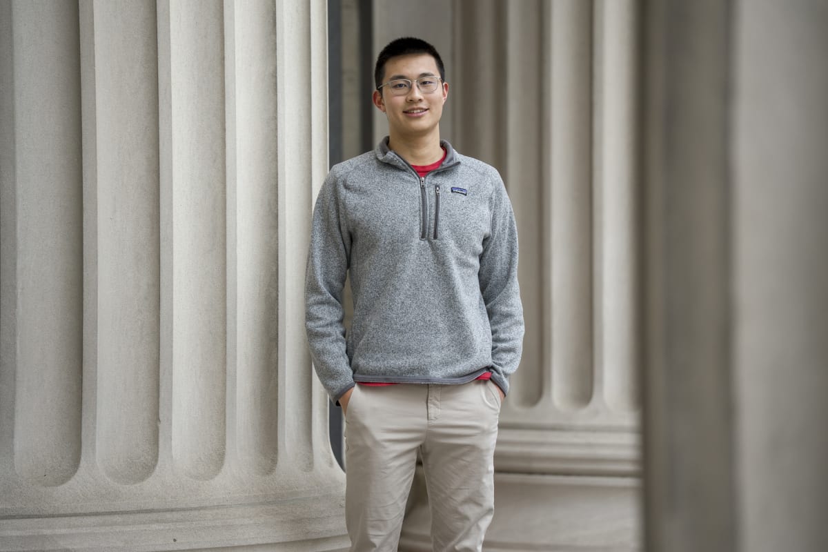 MIT senior Alex Tang in lab setting, future physician-scientist and cancer researcher
