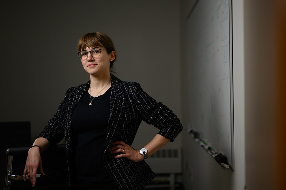 MIT Professor Sophia Henneberg standing in laboratory discussing stellarator fusion reactor optimization research