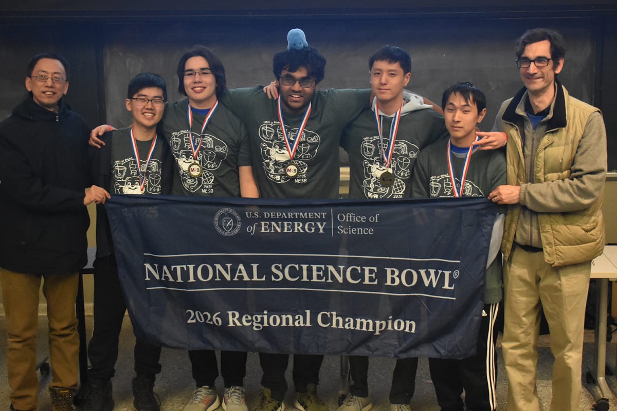 High school students in green Science Bowl shirts compete with buzzers in MIT classroom
