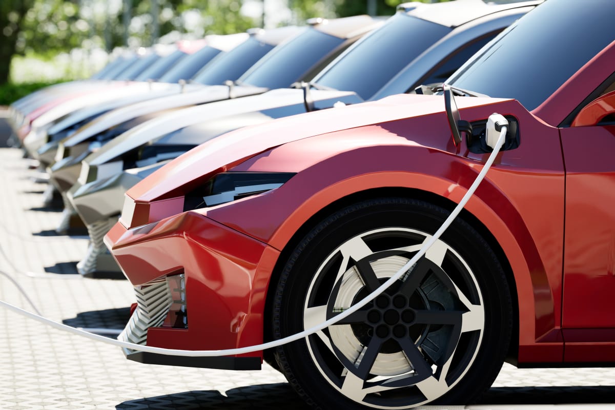 Electric vehicle charging in sunny parking lot with modern charging station