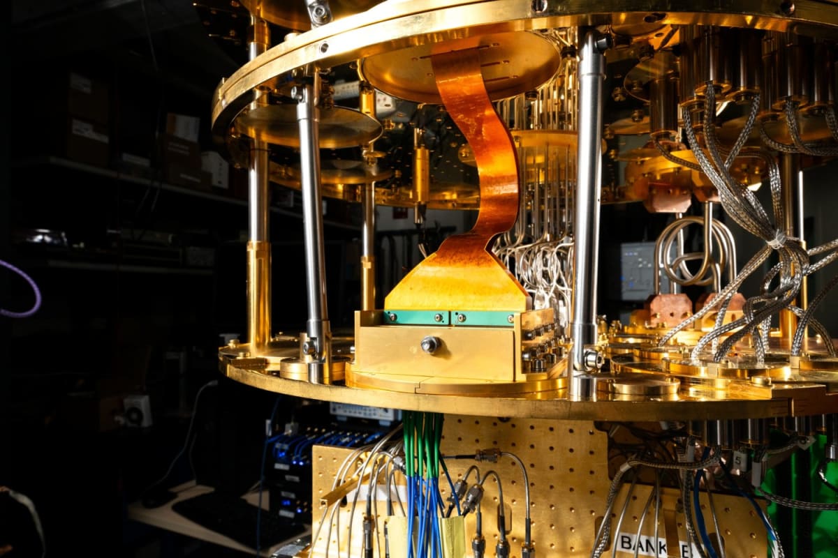 Copper-colored flexible ribbon cables installed inside dilution refrigerator for quantum computing system testing