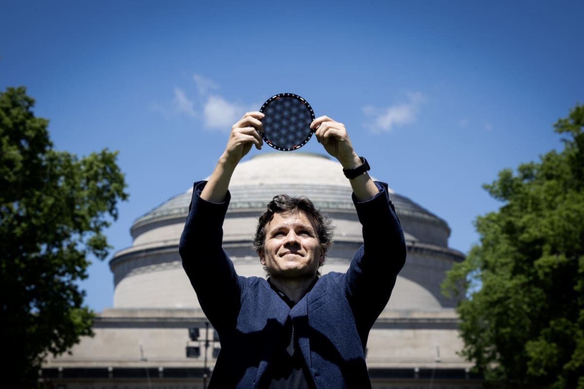 MIT physics professor Pablo Jarillo-Herrero standing in laboratory holding graphene sample