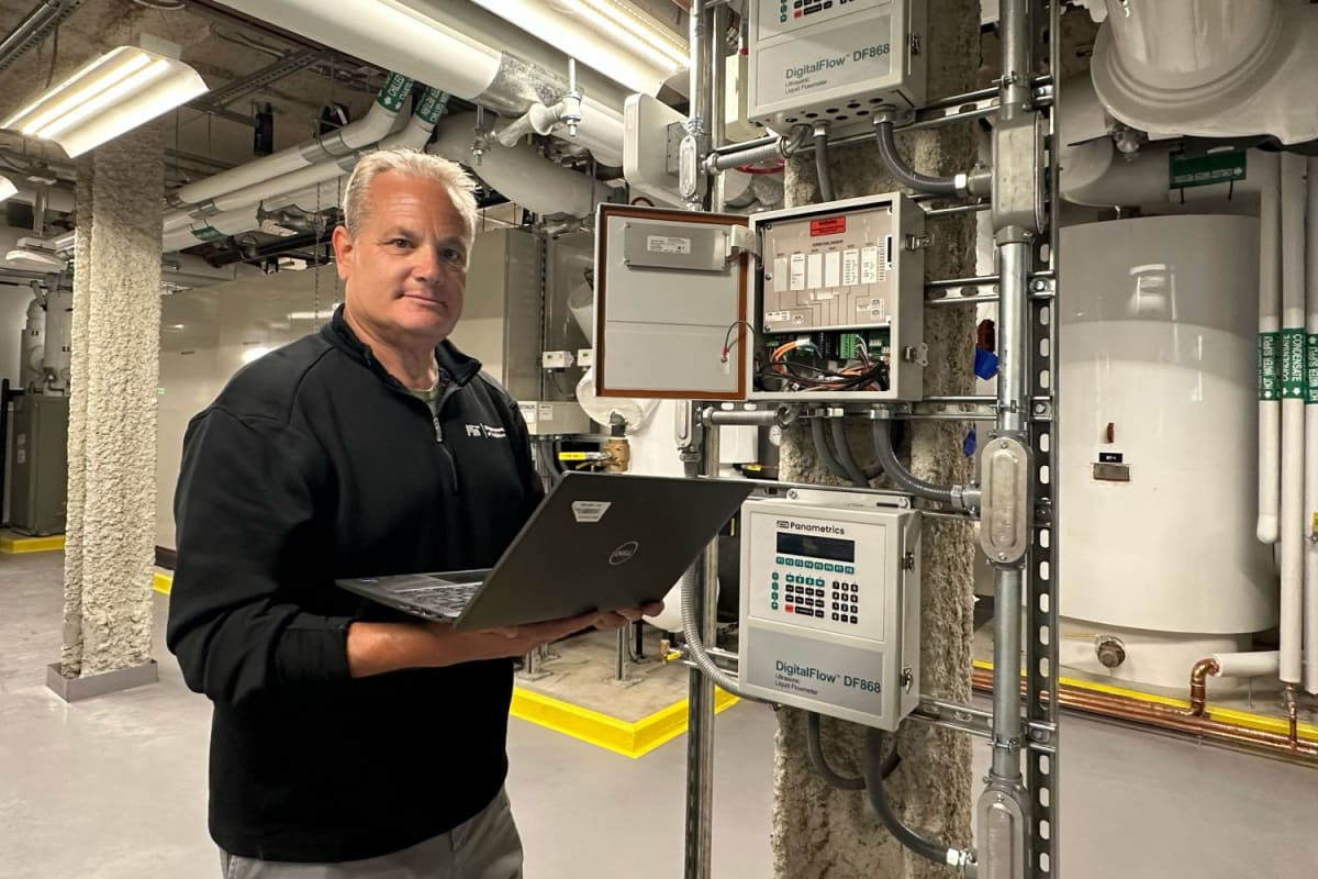 Engineer Fran Selvaggio stands in MIT's renovated warehouse featuring innovative heat-recovery technology