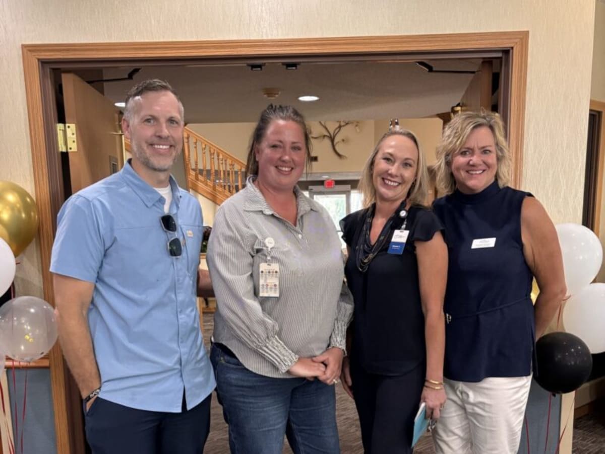 Four professionals celebrating leadership award with Melissa McCorquodale at Good Samaritan Ridge View Estates