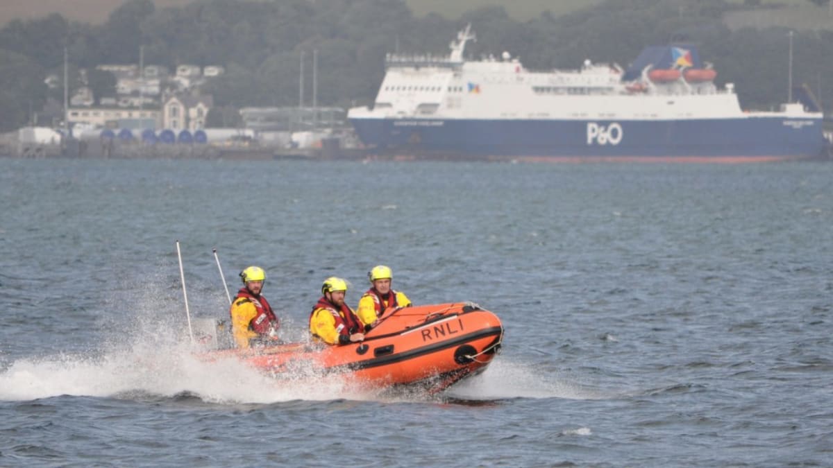 RNLI lifeboat crew responding to capsized sailing vessel at Loch Ryan near Stranraer