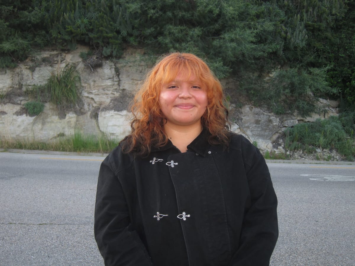 College student Rebecca Oregel smiling at UC Santa Cruz campus, first-generation graduate and scholarship recipient