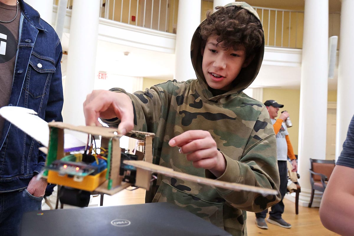 Seventh grade student demonstrates handmade robotic Venus flytrap with sensors and servos at UVA Rotunda