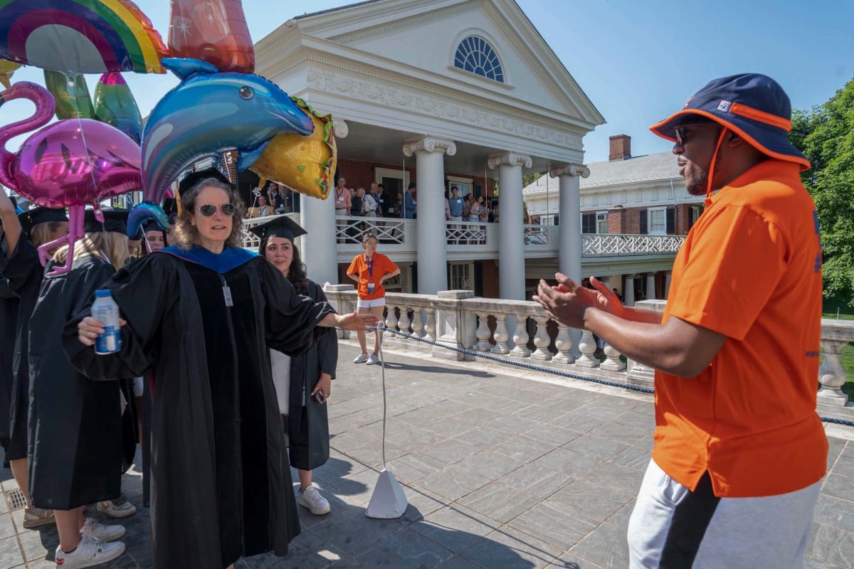 Graduate in cap and gown celebrates during University of Virginia Final Exercises ceremony