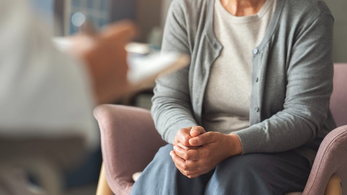 Healthcare provider discussing menopause treatment options with middle-aged female patient in medical office