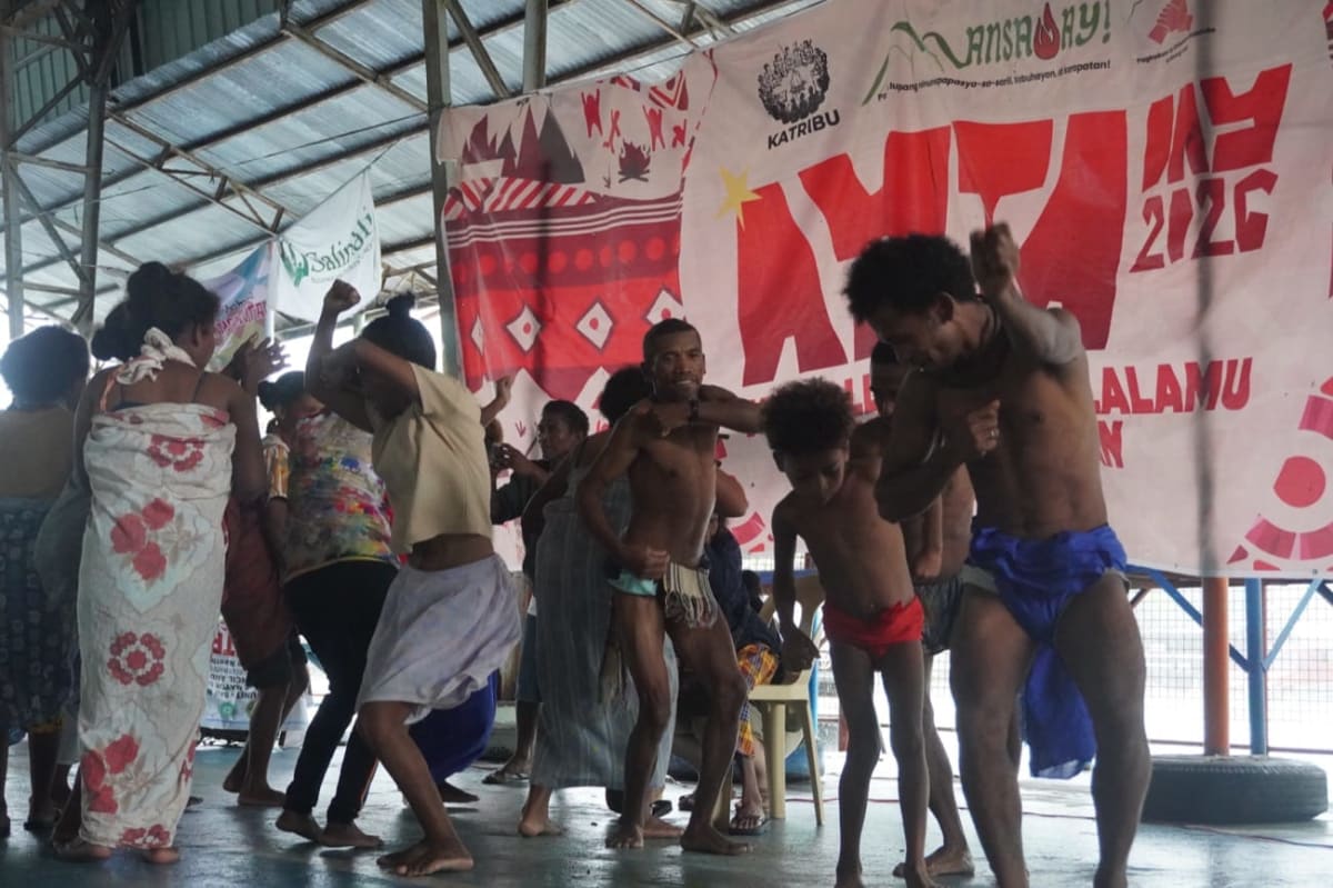 ** Aeta community members gathering indoors during unity celebration in Zambales, Philippines