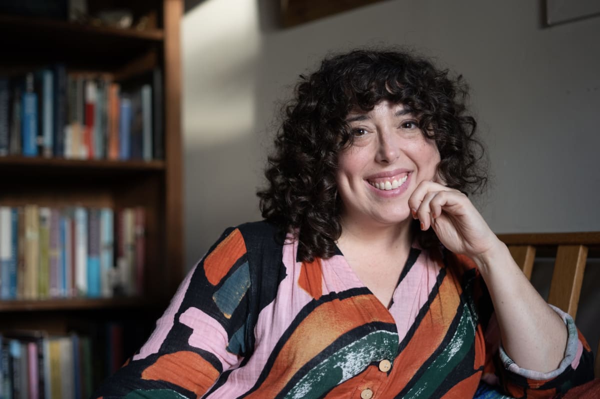 Journalist Shoshana Walter holding her book "Rehab: An American Scandal" about addiction treatment reform