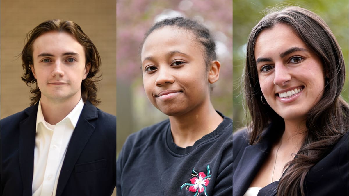 Smiling Fordham University students holding scholarship award certificates on campus