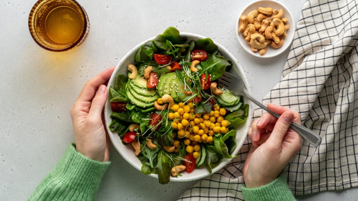 Colorful array of fiber-rich foods including oats, beans, fruits, vegetables, and whole grains
