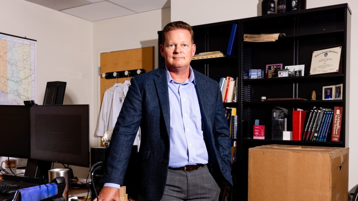 Medical examiner Greg Hess at his Tucson office desk working on heat death tracking