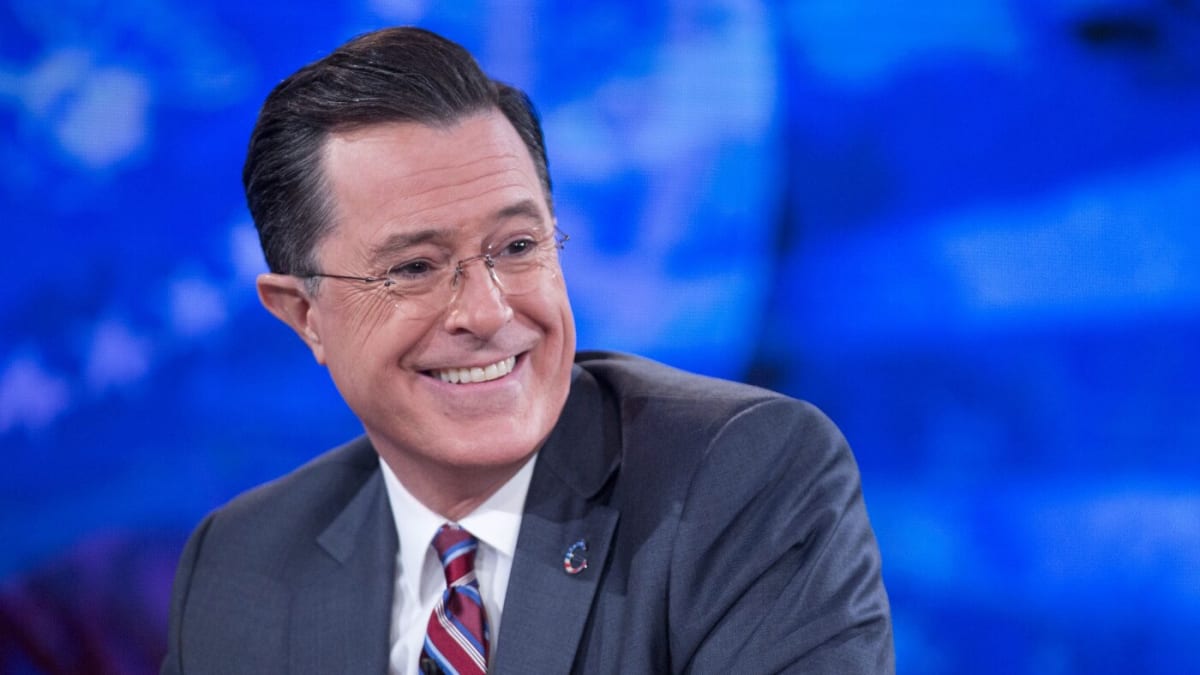 Stephen Colbert smiling during a taping of Comedy Central's The Colbert Report in 2014