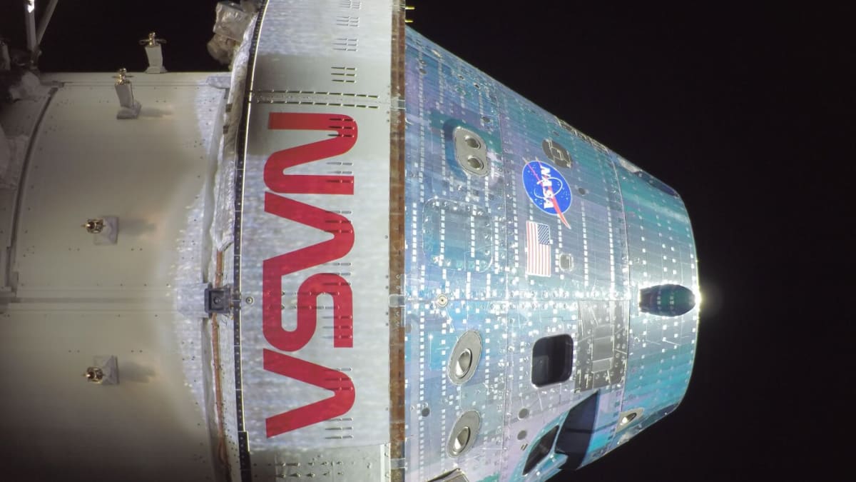 NASA astronaut Christina Koch looking at Earth through Orion spacecraft window during historic moon mission