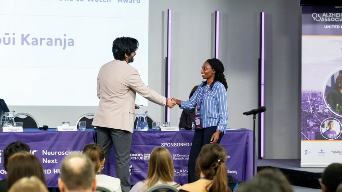 Wambūi Karanja receiving One to Watch award from Alzheimer's Association at ceremony
