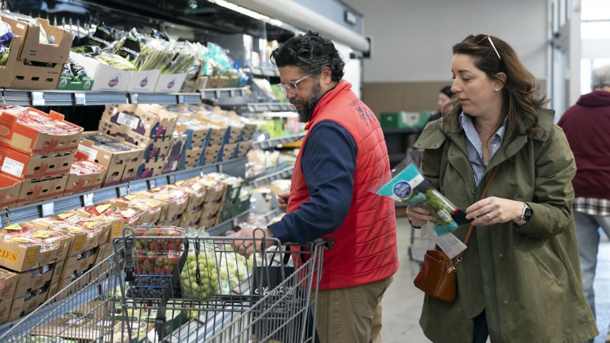 Family shopping in Aldi grocery store aisle looking at products on shelves