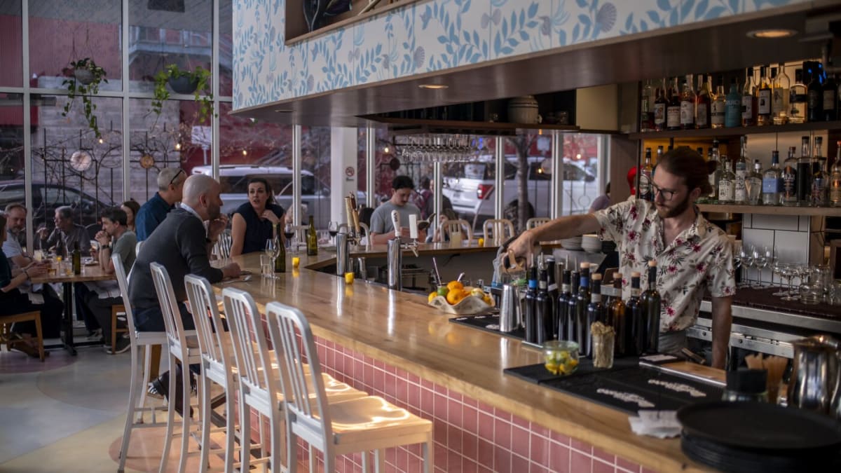 Bartender pouring drink at L'Oca d'Oro Italian restaurant in Austin Texas