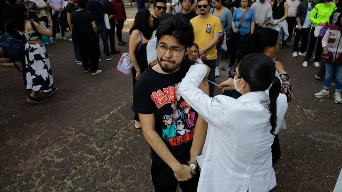 Medical personnel administering measles vaccines to waiting families at Mexico City vaccination center