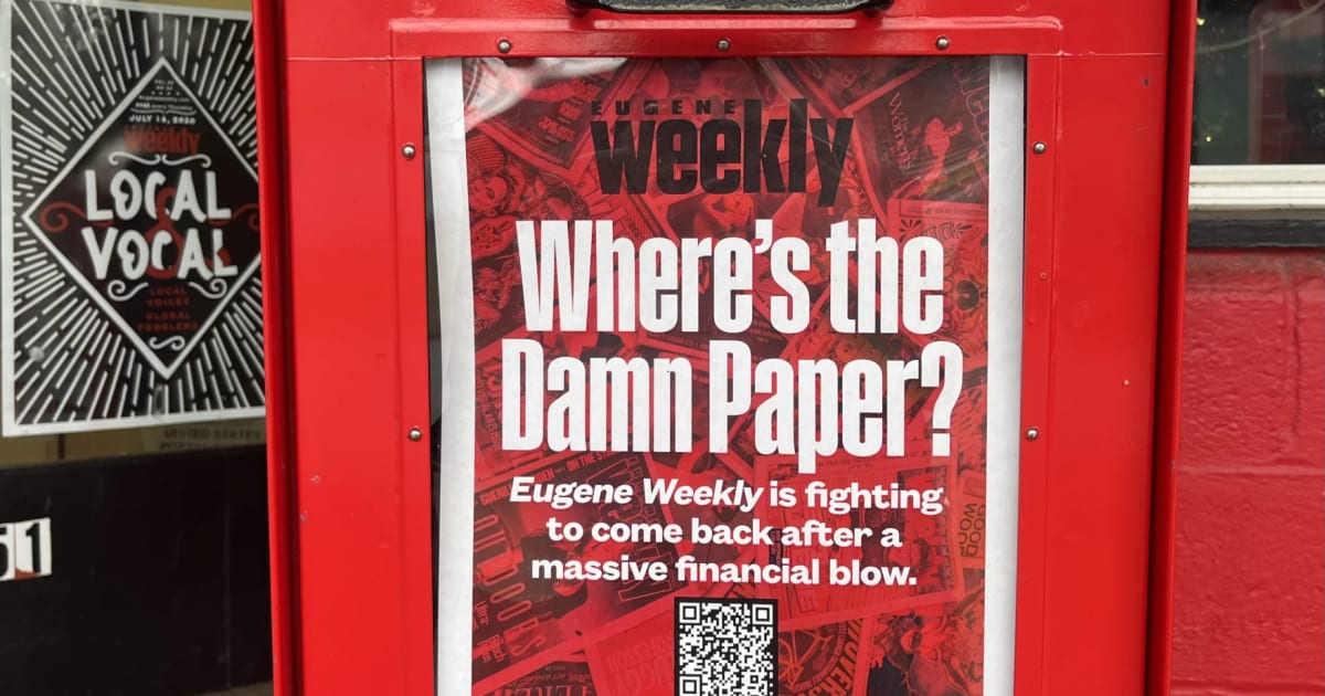 Red newspaper distribution box for Eugene Weekly on a street corner in Eugene, Oregon
