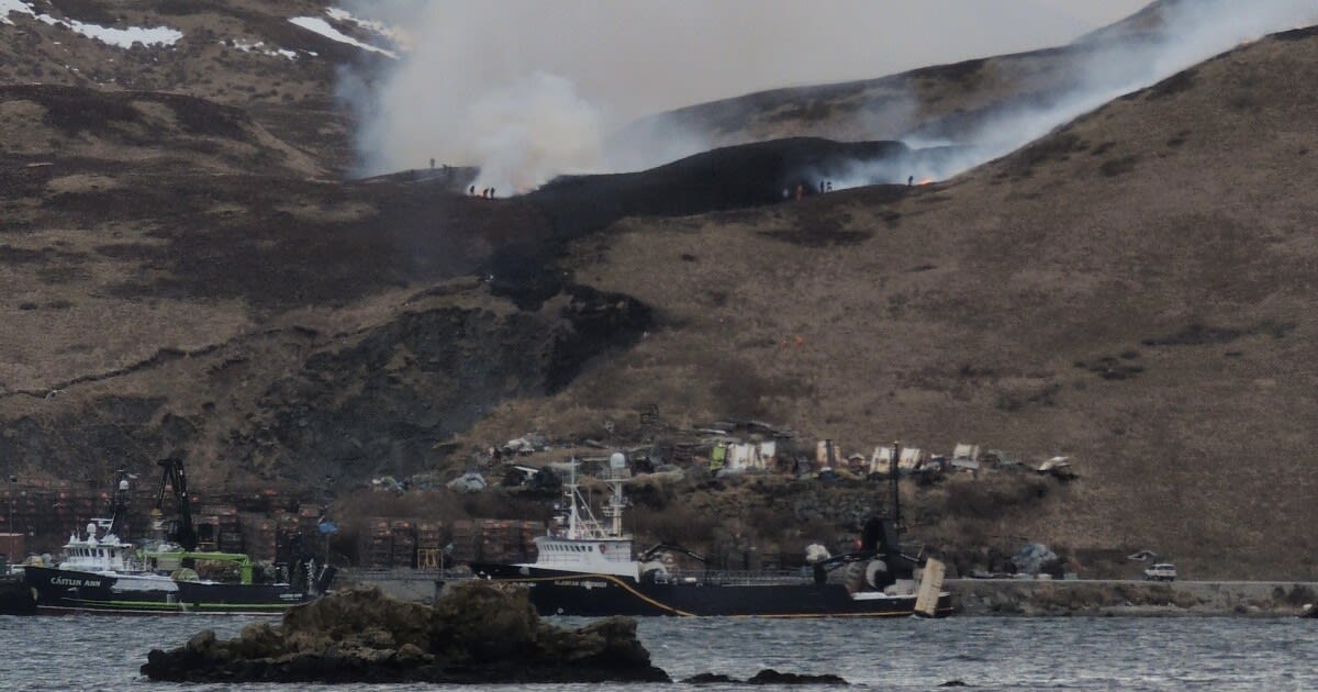 Tundra fire burning on hillside above Westward Seafoods in Unalaska, Alaska