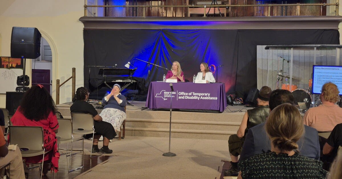 Council members Barbara Guinn and Kate Breslin seated at table during child poverty public hearing