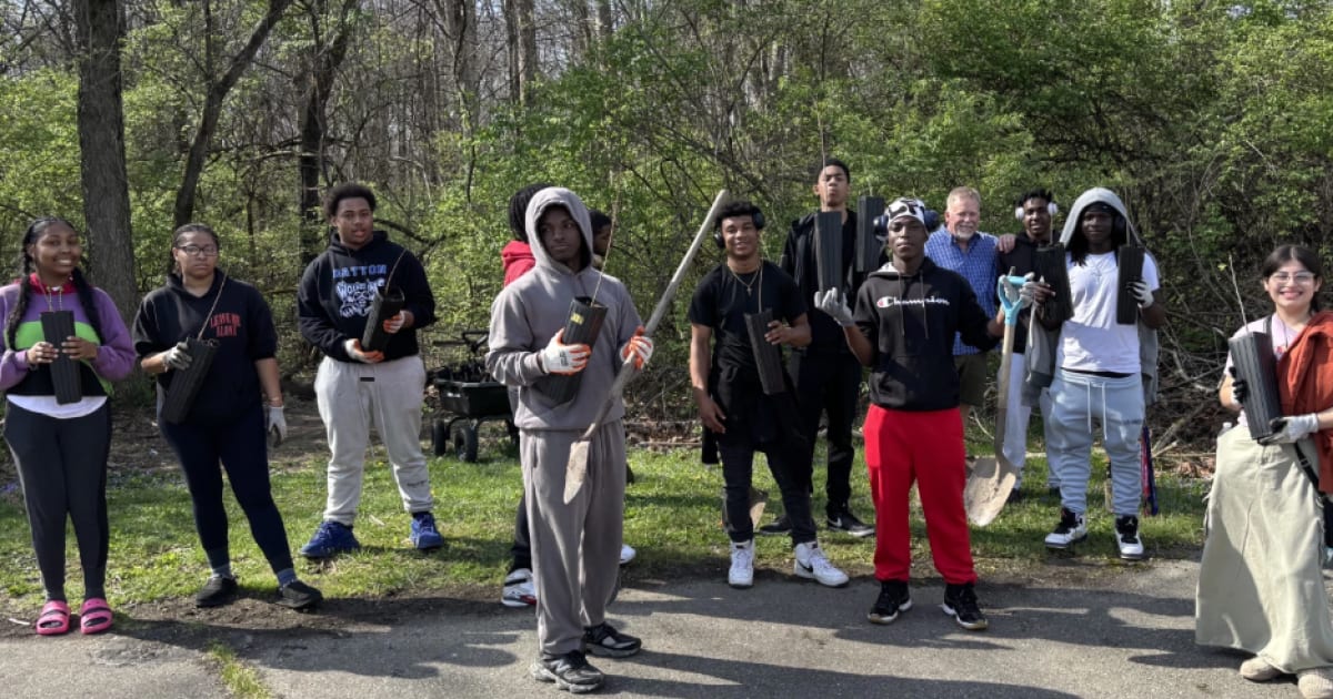 Dunbar High School students planting native trees in Dayton park for environmental restoration project