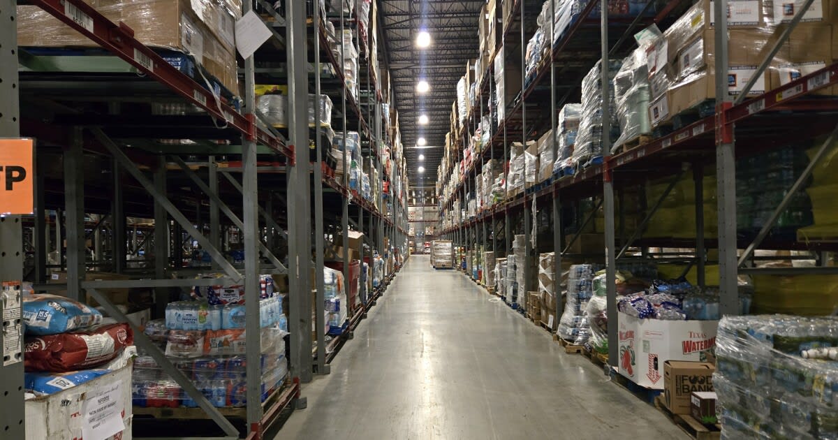 Volunteers loading boxes of donated food at the San Antonio Food Bank warehouse