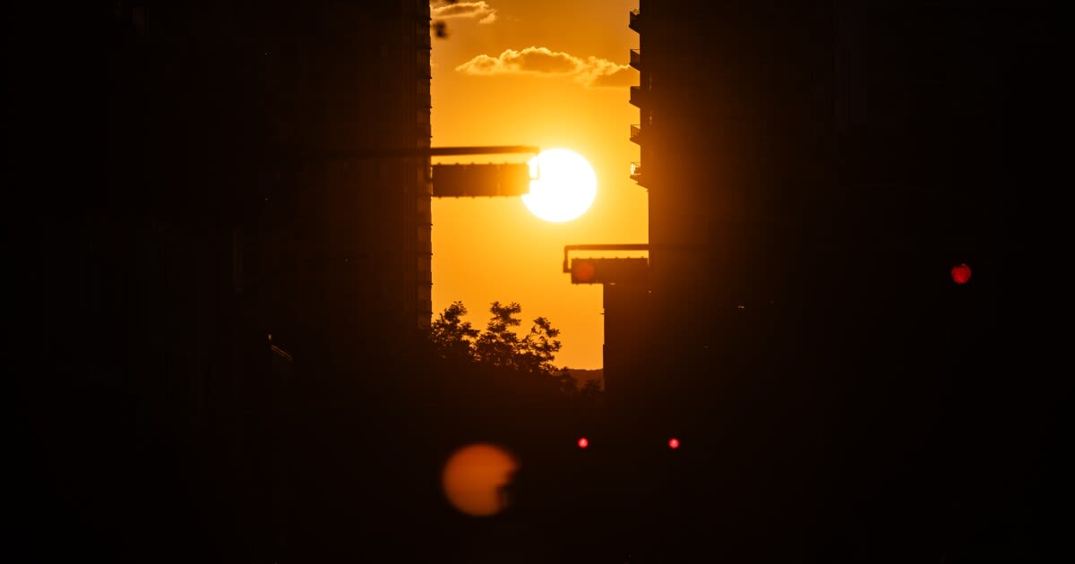 Golden sunset creating a glowing light tunnel down Austin's Fourth Street during Austinhenge