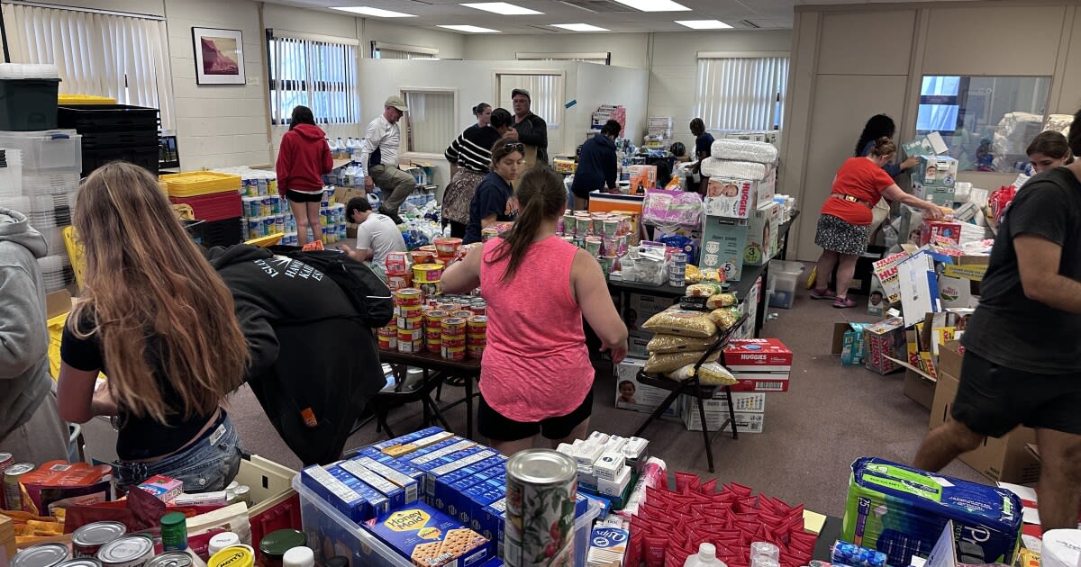 Volunteers unloading shipping containers of donated supplies and food at Molokaʻi community relief hub