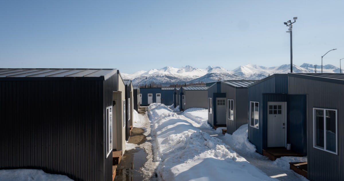 Small wooden tiny home exterior with window, part of Anchorage homeless treatment program