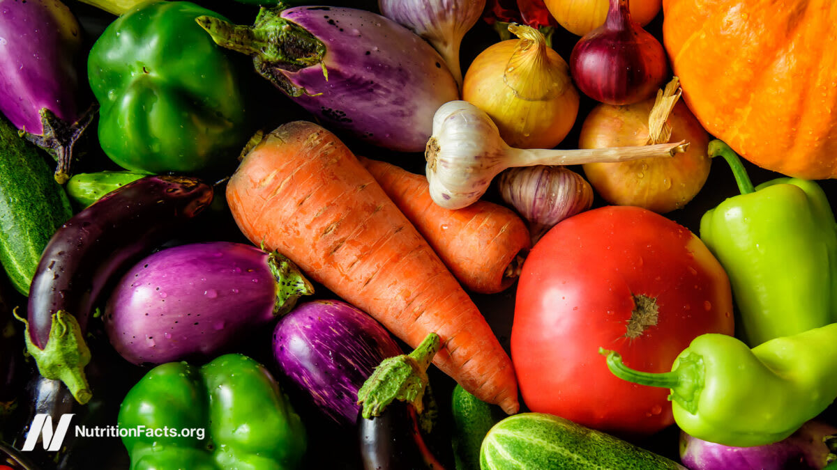 Colorful array of fresh vegetables, fruits, berries and whole grains on kitchen counter