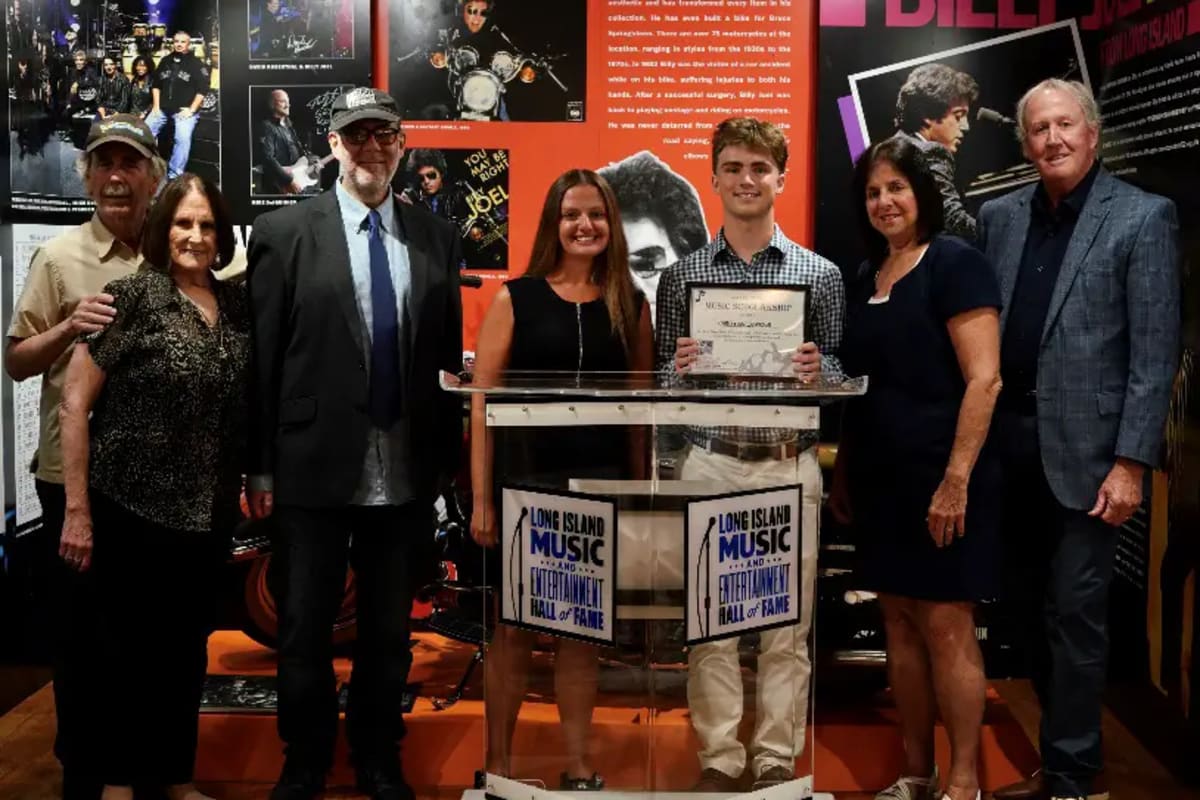 High school students with musical instruments celebrating scholarship awards from Long Island Music Hall of Fame