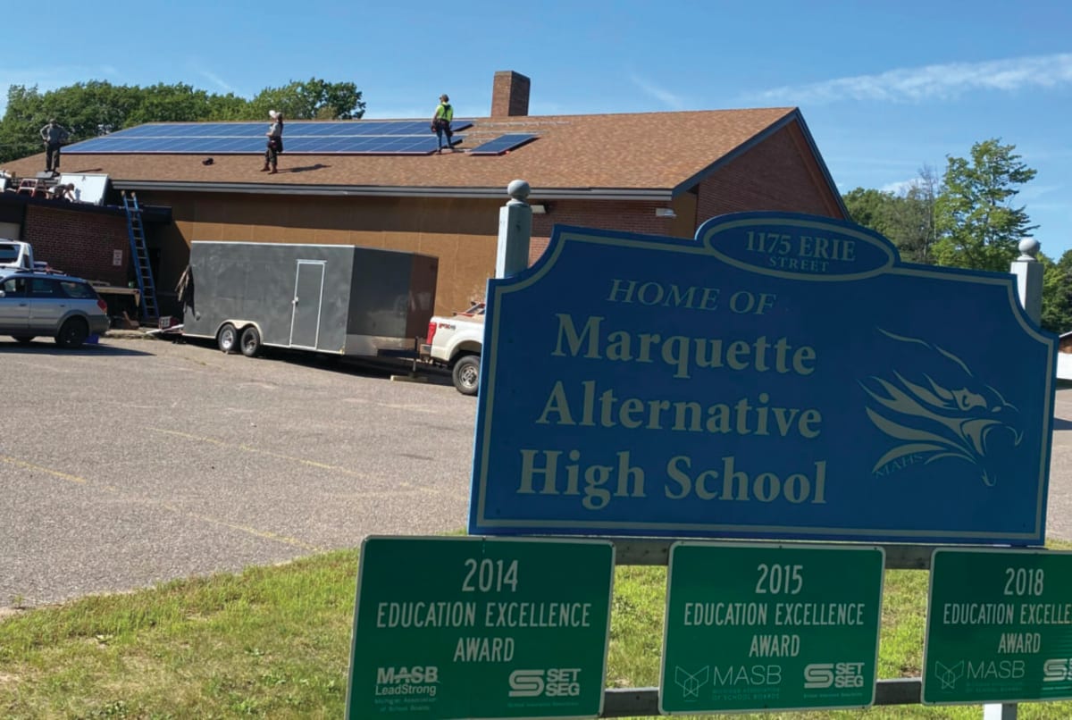 Solar panels being installed on roof of Marquette Alternative High School in Michigan