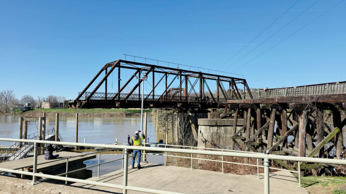 Volunteers and engineers manually cranking gears to rotate historic Harmar Bridge during inspection in Marietta Ohio