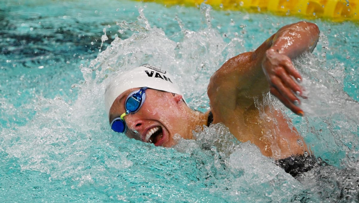 Taylor Ruck celebrating after winning gold medal at Canadian Swimming Trials in Montréal pool