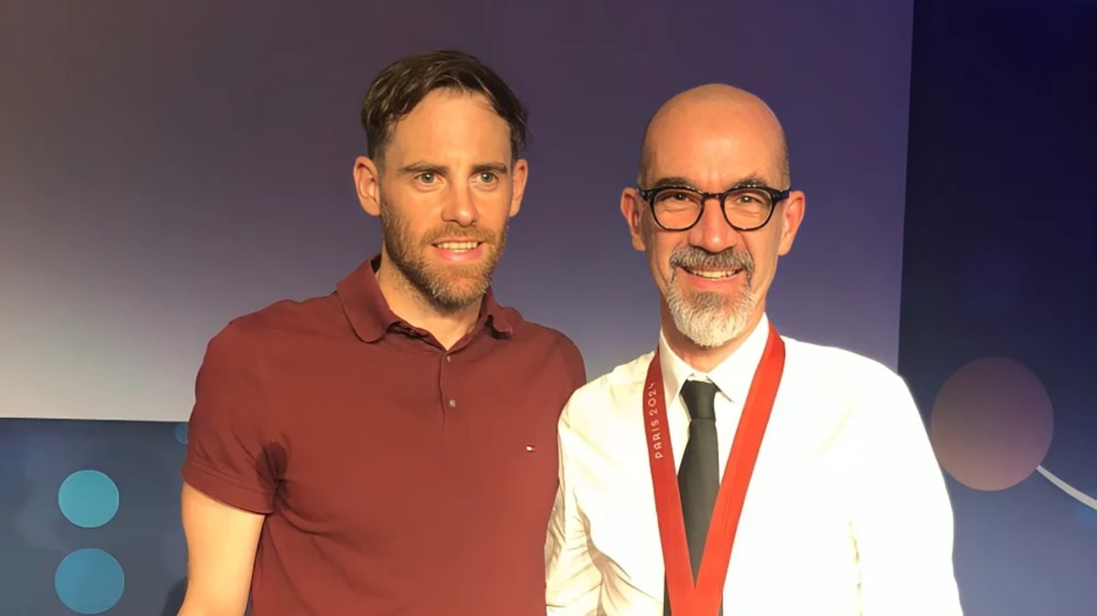 Oncologist Dr. David Planchard meeting Paralympic triathlon champion Thibaut Rigaudeau at Paris 2024 celebration event