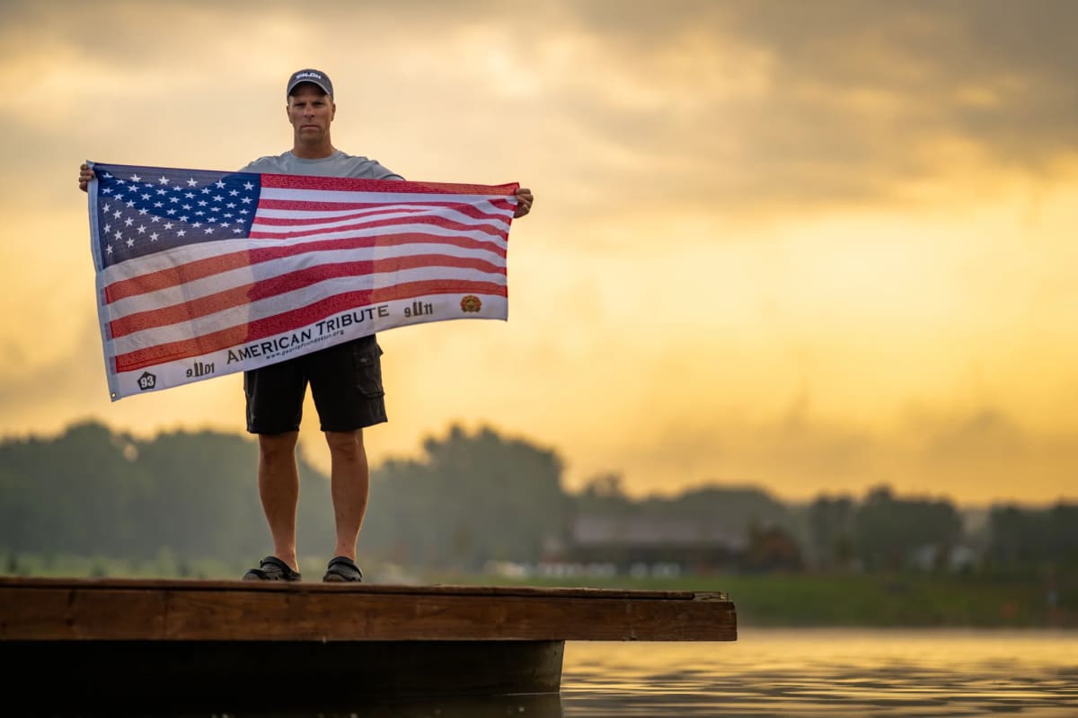 Fisherman Jeff Kolodzinski holding fishing pole over water during 24-hour marathon fishing event