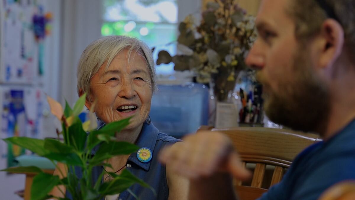 Hiroshima survivor Hideko Tamura Snider stands beside urban forester with peace tree saplings