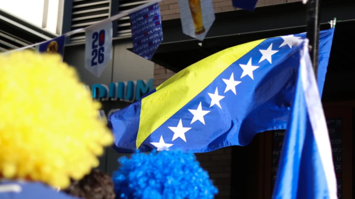 Fans wave large Bosnia and Herzegovina flag in Seattle's Pioneer Square celebrating World Cup victory