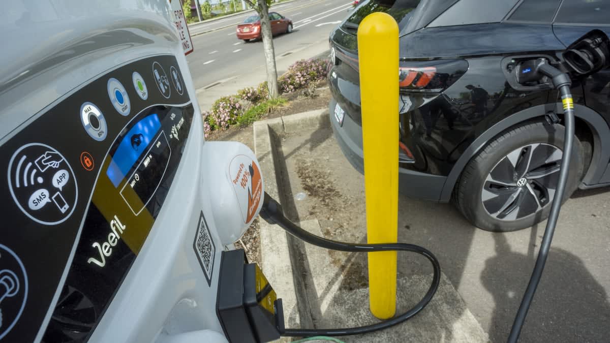 Electric vehicle charging at public charging station in Oregon during daytime