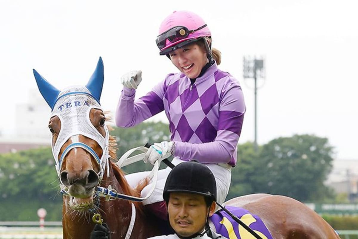 Jockey Seina Imamura celebrating on horseback after winning historic Oaks race at Tokyo Racecourse